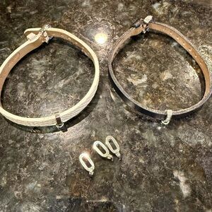 Cartier leather and 18k gold bracelets with charm slides. One has diamonds